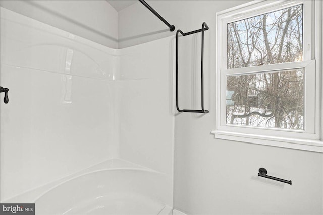 bathroom featuring tub / shower combination and a wealth of natural light