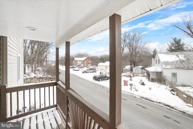 snow covered deck with covered porch