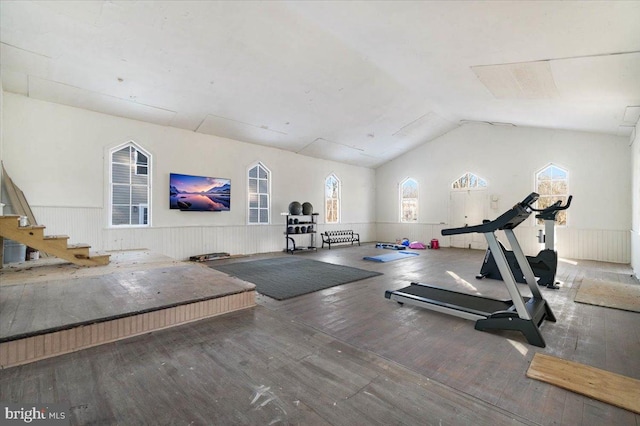 exercise area with hardwood / wood-style floors and vaulted ceiling