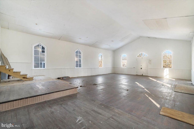 unfurnished living room featuring lofted ceiling and wood-type flooring