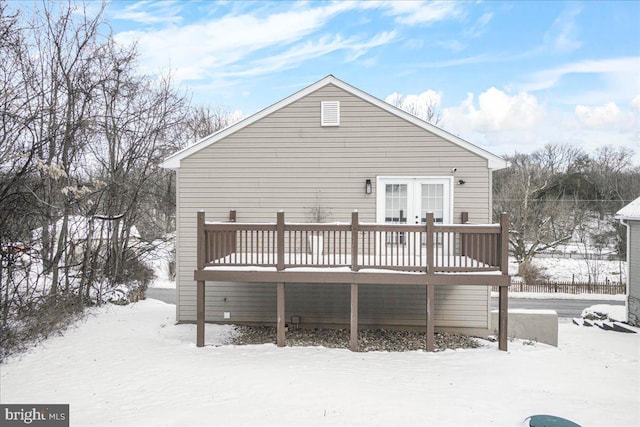 snow covered property featuring french doors and a deck