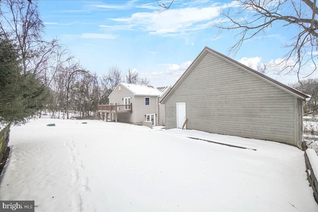 view of snow covered rear of property