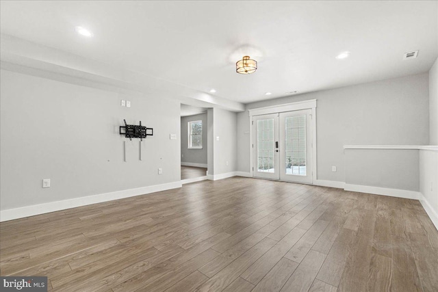 empty room featuring wood-type flooring and french doors