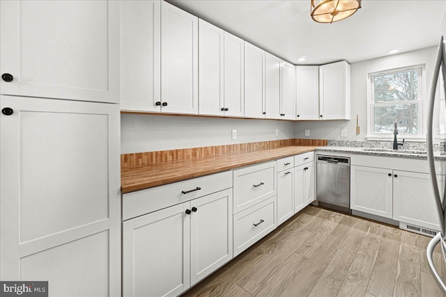 kitchen featuring sink, light hardwood / wood-style floors, white cabinets, and dishwasher