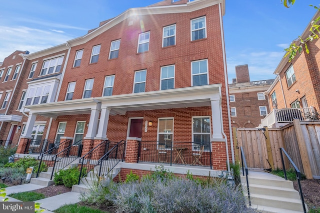 townhome / multi-family property featuring a porch