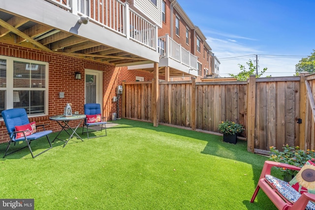 view of yard featuring a balcony