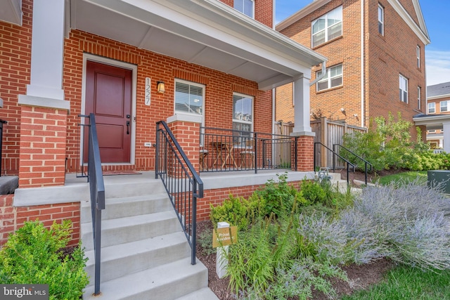 entrance to property featuring covered porch