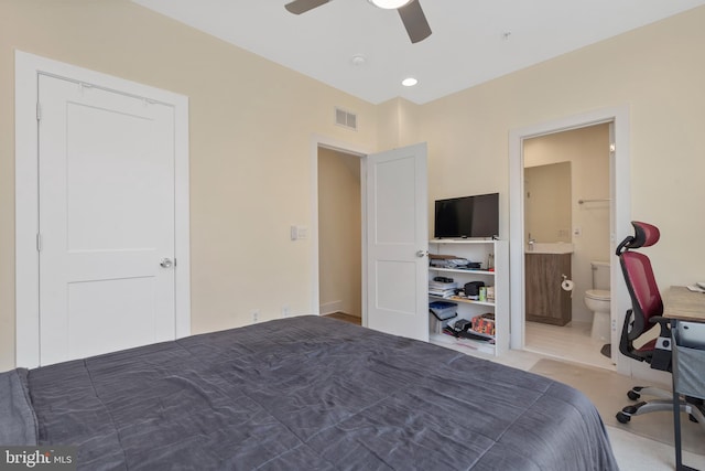 unfurnished bedroom featuring ceiling fan and connected bathroom