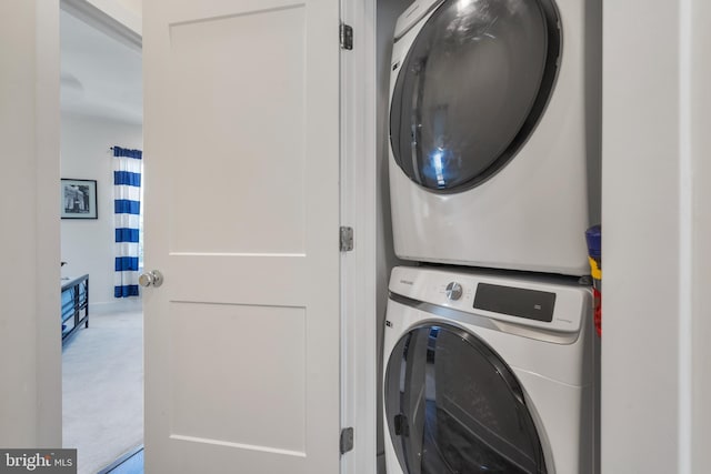 laundry room with stacked washer / dryer