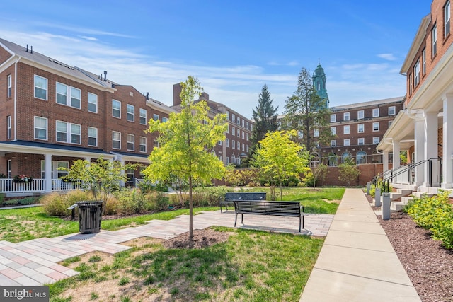 view of home's community featuring a yard and a patio area