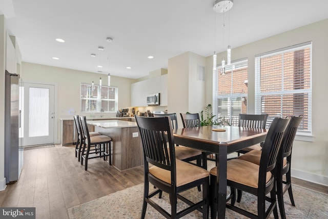 dining space with light hardwood / wood-style floors