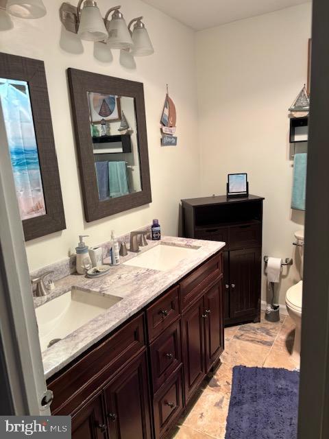 bathroom featuring vanity and toilet