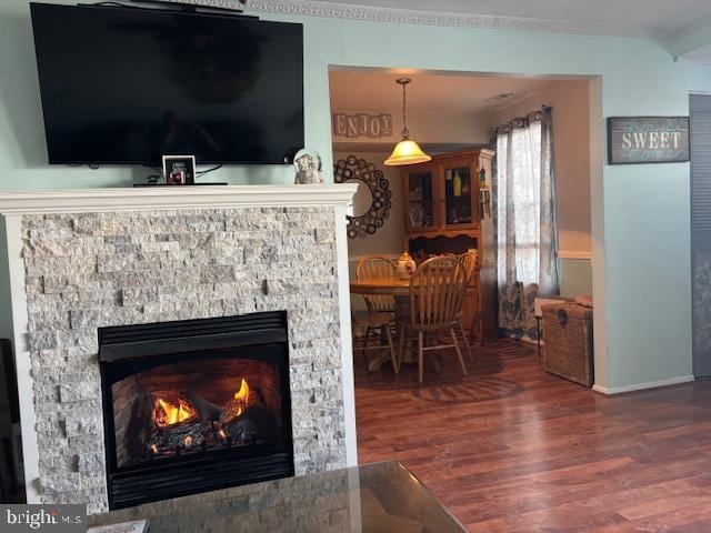 interior details with a stone fireplace and hardwood / wood-style floors