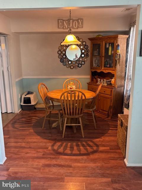 dining area featuring dark wood-type flooring