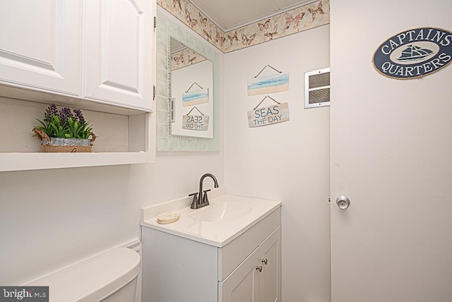 bathroom featuring vanity and toilet