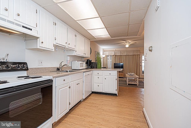 kitchen featuring sink, kitchen peninsula, white appliances, light hardwood / wood-style floors, and white cabinets