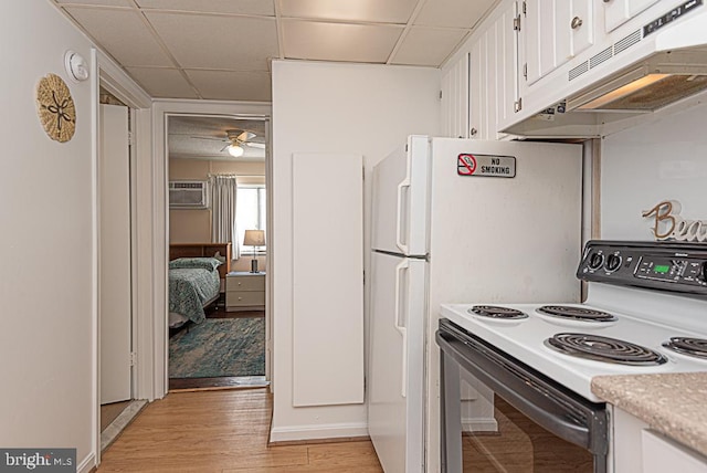 kitchen with white cabinetry, a drop ceiling, light hardwood / wood-style floors, and electric stove