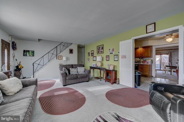 carpeted living room with ceiling fan