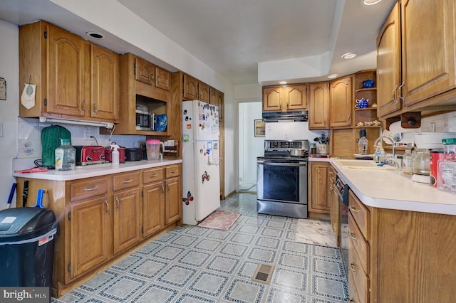 kitchen featuring extractor fan, sink, stainless steel range with electric cooktop, decorative backsplash, and white refrigerator