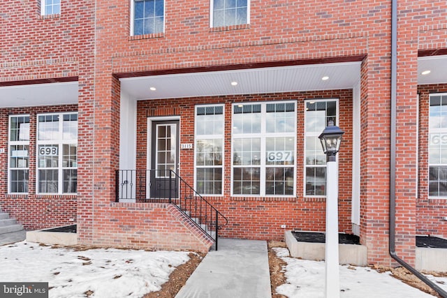 view of snow covered property entrance