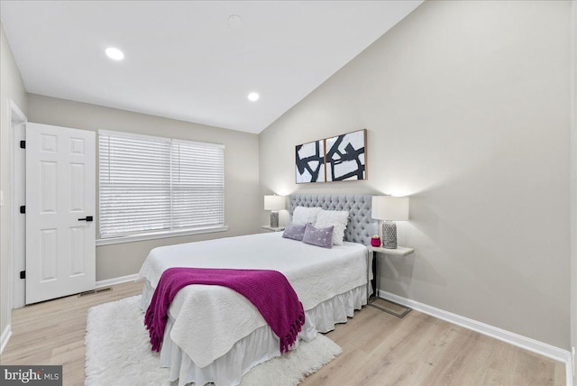 bedroom featuring vaulted ceiling and light hardwood / wood-style flooring