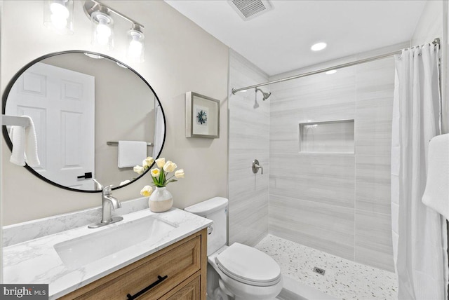 bathroom with vanity, curtained shower, and toilet