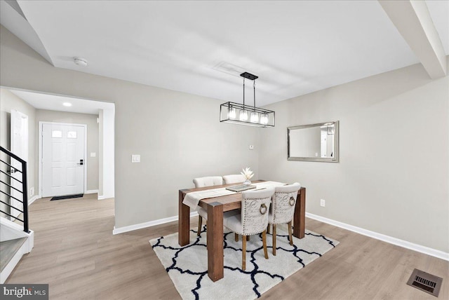 dining room with an inviting chandelier and light hardwood / wood-style floors