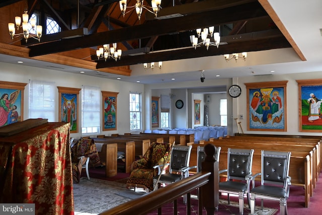 interior space with a notable chandelier, beam ceiling, and high vaulted ceiling