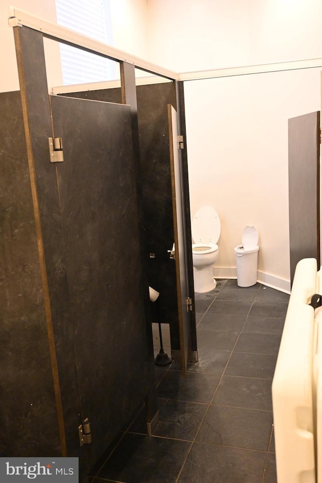 bathroom featuring tile patterned flooring and toilet