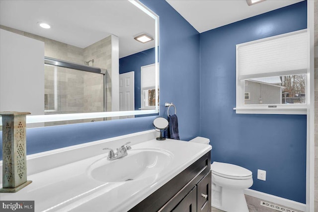 bathroom with vanity, an enclosed shower, and toilet