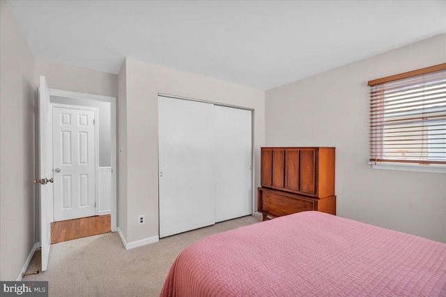 carpeted bedroom with a closet