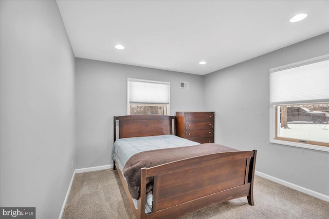 carpeted bedroom featuring multiple windows