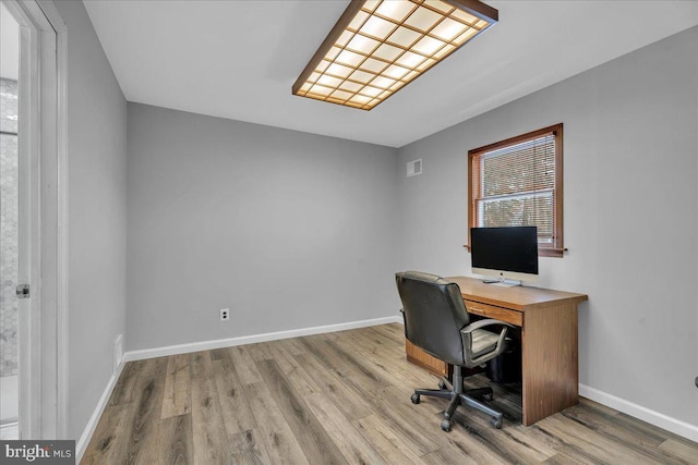 office with light hardwood / wood-style floors