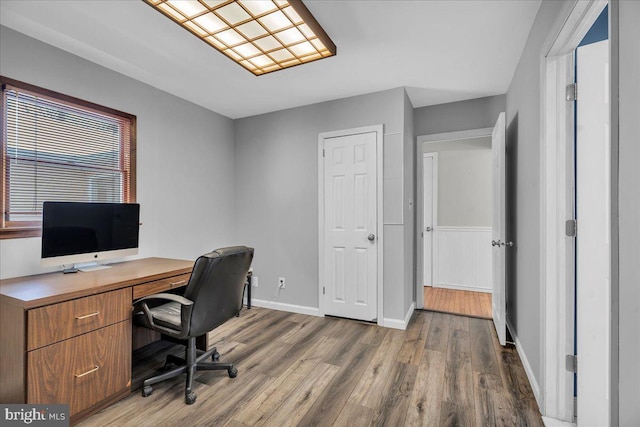 home office with hardwood / wood-style flooring