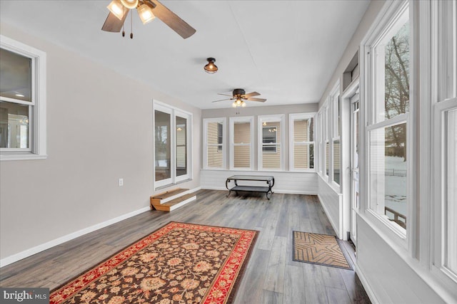 sunroom featuring ceiling fan