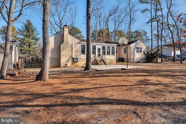 rear view of house featuring central AC and a patio area