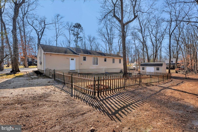 back of property featuring a storage unit