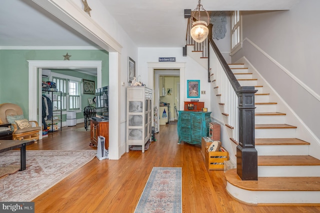 entrance foyer featuring hardwood / wood-style flooring and ornamental molding