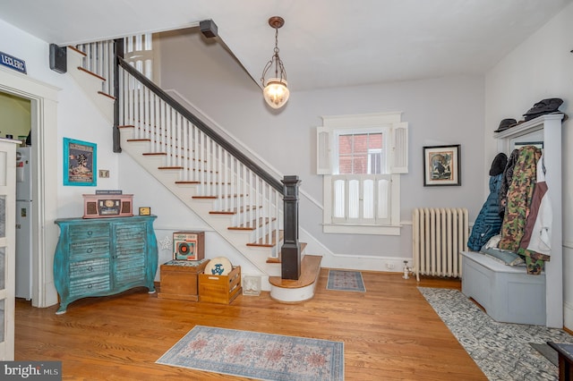 foyer entrance featuring radiator and hardwood / wood-style floors