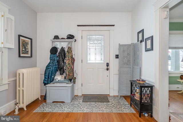 entryway featuring radiator heating unit and light hardwood / wood-style floors