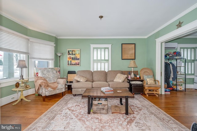 living room featuring a wall mounted air conditioner, crown molding, and wood-type flooring