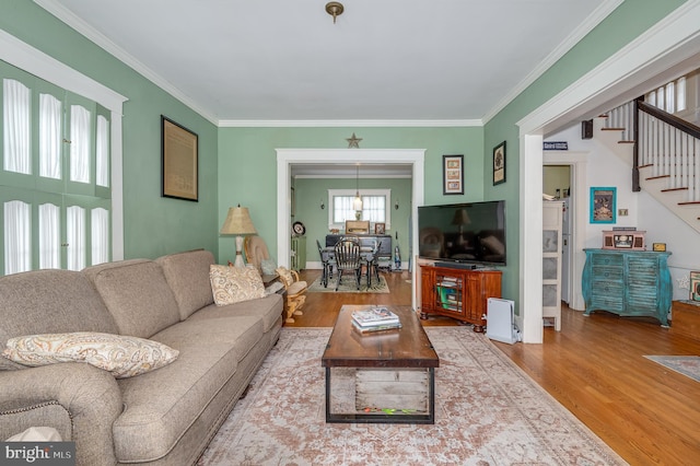 living room featuring wood-type flooring and ornamental molding