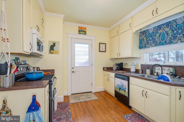 kitchen with dishwasher, ornamental molding, stainless steel range with electric cooktop, cream cabinetry, and light wood-type flooring