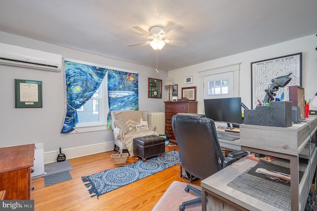 office space featuring hardwood / wood-style floors, a wall mounted air conditioner, a healthy amount of sunlight, and radiator heating unit