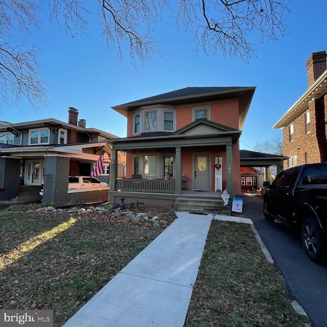 view of front of home featuring covered porch and a front yard