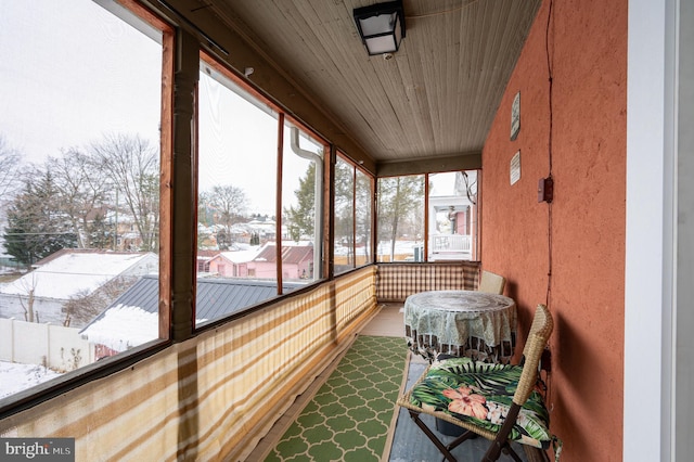 sunroom / solarium featuring wood ceiling