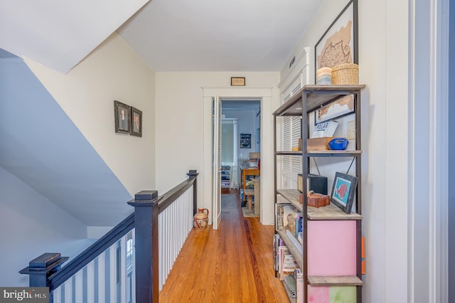 corridor with hardwood / wood-style flooring