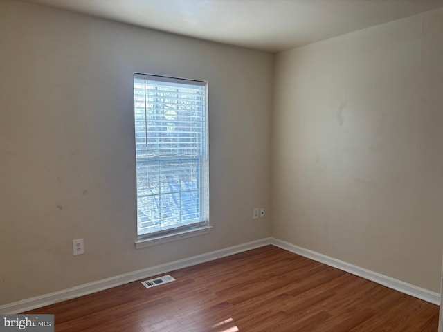 unfurnished room with hardwood / wood-style floors