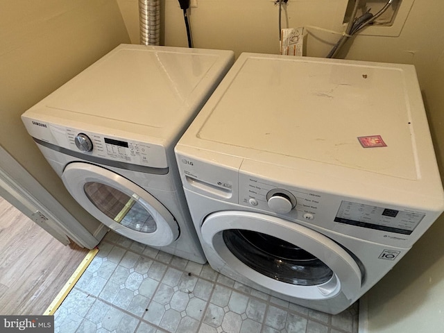 clothes washing area featuring separate washer and dryer