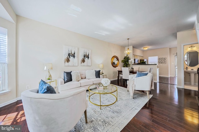 living area featuring baseboards and wood finished floors